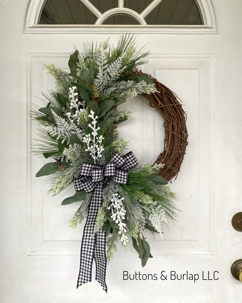 Winter wreath with iced stems and plaid bow