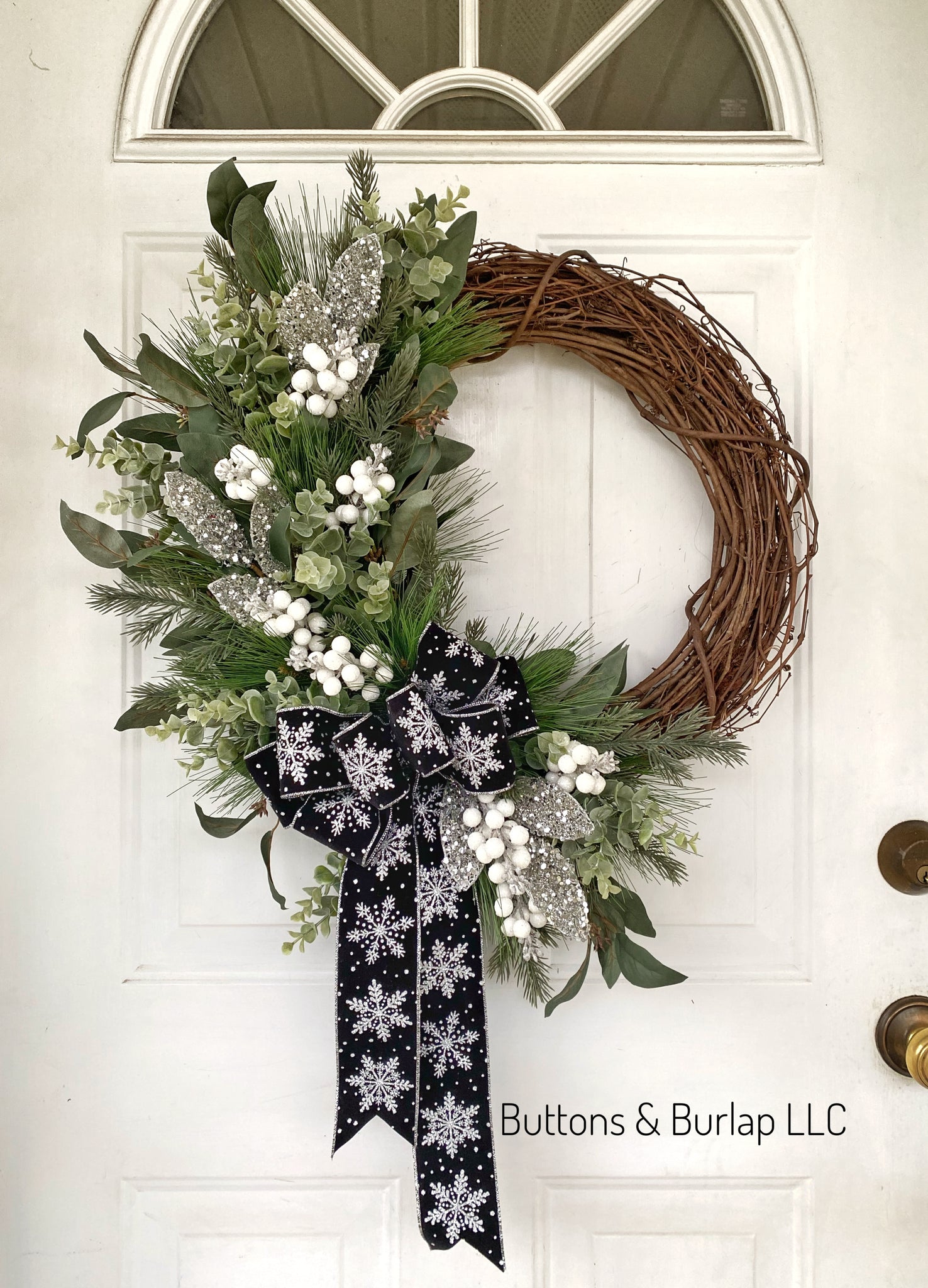 Winter wreath with black snowflake bow